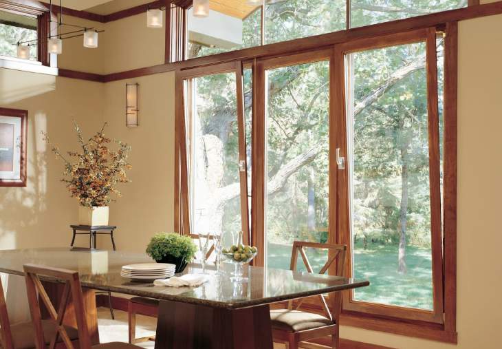Dining room with full-height wood windows onto the garden